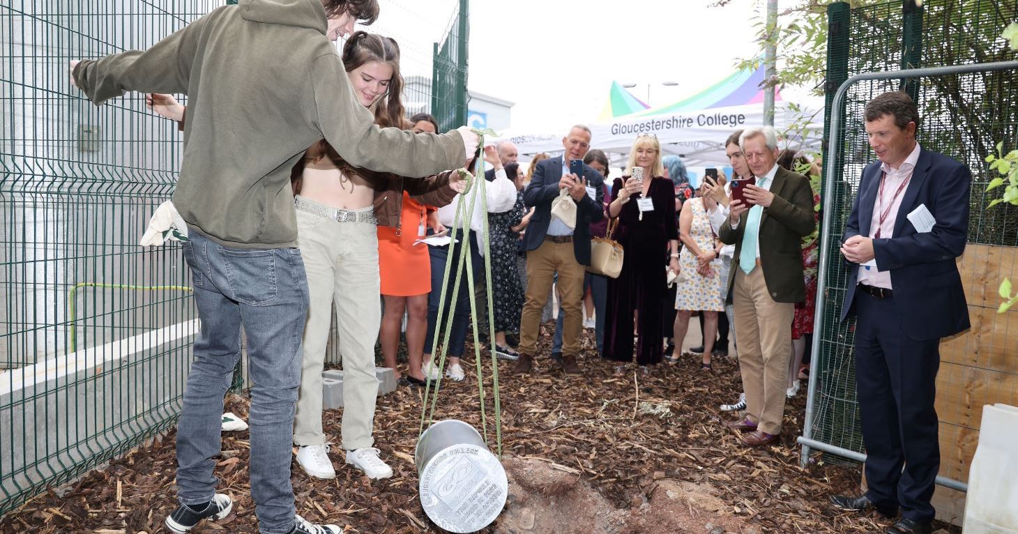 Gloucestershire College principal and CEO, Matthew Burgess, supporters and partners look on as students bury a time capsule to mark the college's move to 100 per cent renewable energy.