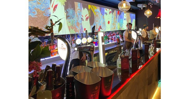 The new KIBOUsushi includes a dedicated bar with striking, moving digital artwork.
