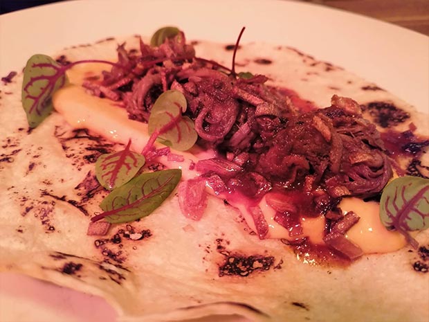 Delicious smoked pulled beef tortilla with chipotle and sesame dressing.