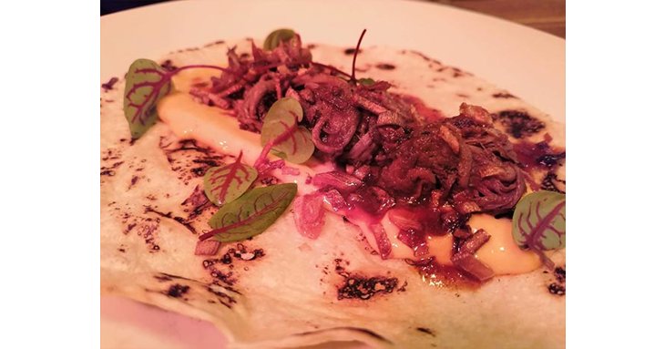Delicious smoked pulled beef tortilla with chipotle and sesame dressing.