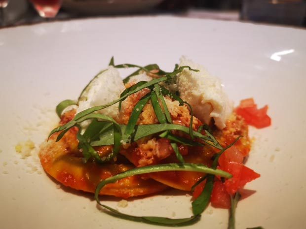 Burrata ravioli with garden tomato sauce.