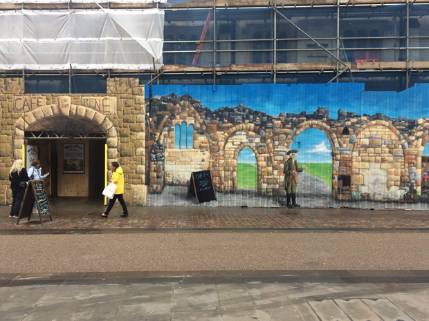 Café Rene employs street artist to improve hoardings