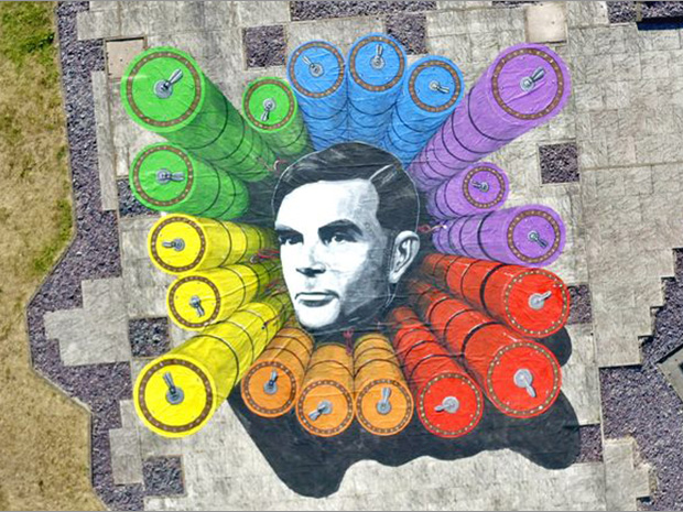 Alan Turing played a vital role in breaking the German Enigma code and a huge rainbow-coloured canvas celebrating his legacy and birthday has appeared at GCHQ.