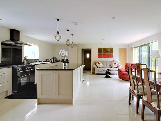 The kitchen benefits from integrated appliances including a Rangemaster cooker, dishwasher and wine cooler.