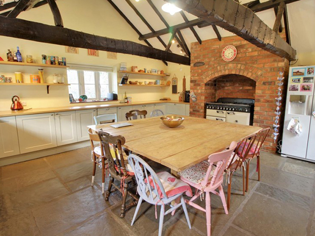 The spectacular kitchen has a vaulted ceiling with exposed beams.
