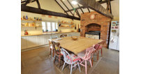 The spectacular kitchen has a vaulted ceiling with exposed beams.