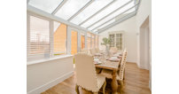 The open plan kitchen and family room leads onto a light, airy conservatory.