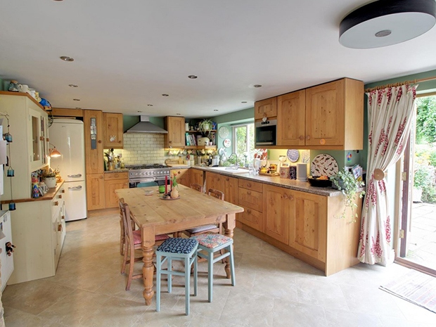The spacious kitchen has room for a family dining table, as well as French doors out to the patio for alfresco dining.