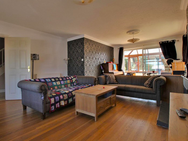 The large lounge has a feature fireplace and leads onto a conservatory.