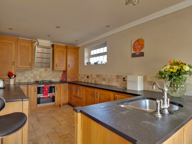 The kitchen has built-in appliances, including a dishwasher.