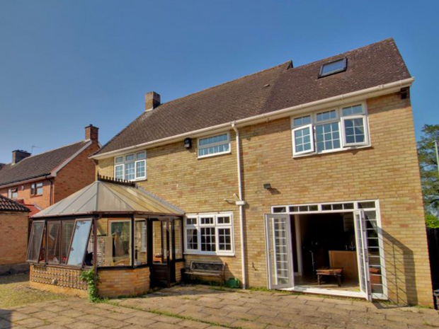 The impressive rear garden has a large patio and even its own fire pit.