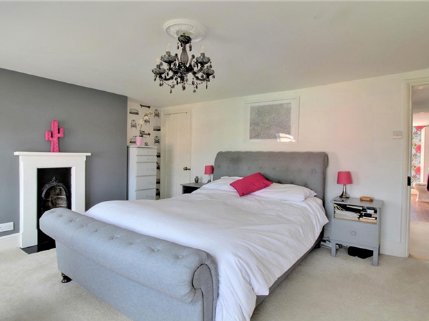 The property has four bedrooms, all with original Victorian fireplaces creating a focal point.