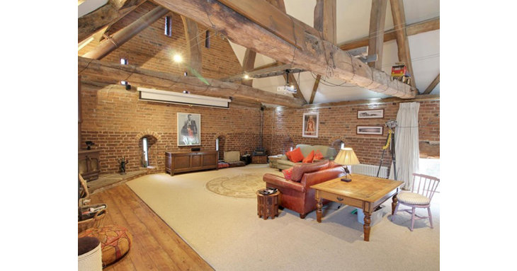 With dreamy exposed brickwork and a vaulted ceiling, the first-floor sitting room is truly spectacular.