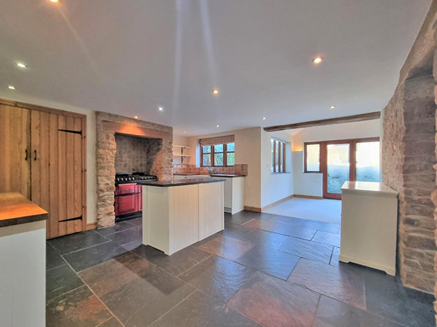 The country kitchen boasts slate floors, granite worktops, exposed stonework and a beautiful ceramic Belfast sink.