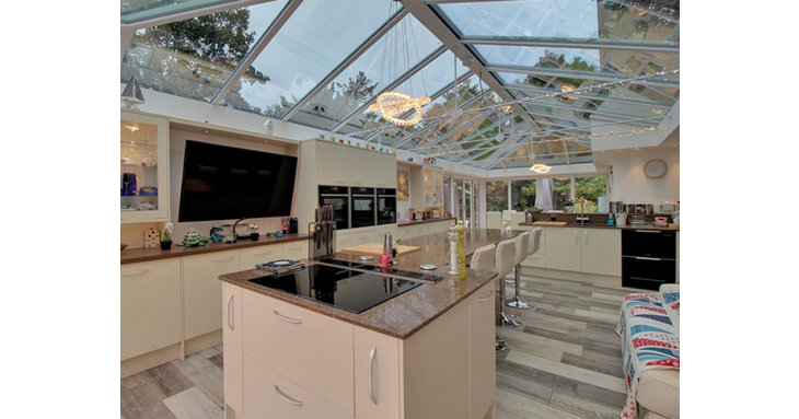 The kitchen, living and dining area features colour changing mood lighting, not to mention three ovens, integrated dishwasher and granite worktops as well as a central island and doors to the garden.