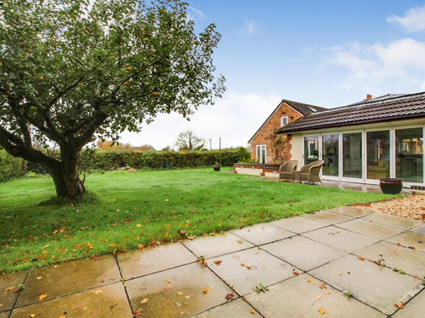 The conservatory, dining room and master bedroom all have doors out into the garden, which has a paved patio and immaculate lawn.
