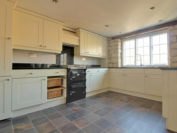 The kitchen is both traditionally charming and modern, with a range cooker and integrated appliances.