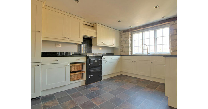 The kitchen is both traditionally charming and modern, with a range cooker and integrated appliances.
