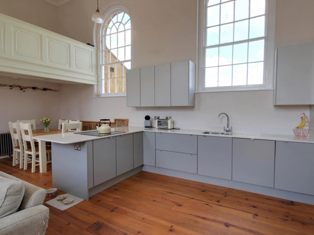The kitchen is finished to a high specification, with sleek gloss units and integrated appliances.