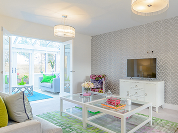 The lounge leads onto a bright, modern conservatory.