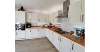 The spacious kitchen benefits from integrated appliances and French doors out onto the garden.