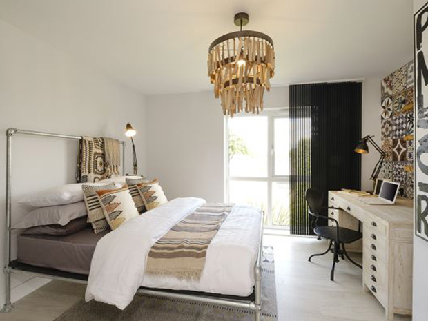 The bright apartment features large windows which allow light to flood in.