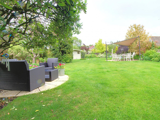The gorgeous rear garden boasts a huge lawn, multiple paved patio areas, ornamental pond, summer house and plenty of space to grow your own fruit and veg.