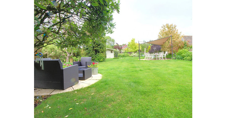 The gorgeous rear garden boasts a huge lawn, multiple paved patio areas, ornamental pond, summer house and plenty of space to grow your own fruit and veg.
