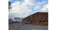 A view from the St Catherine Street entrance with the former SLG warehouse and offices on the right and Kingsholm stadium ahead.