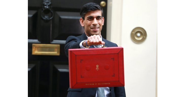 Chancellor Rishi Sunak shows off the famous red Budget case outside number 11 Downing Street. Picture credit Cubankite/Shutterstock.com