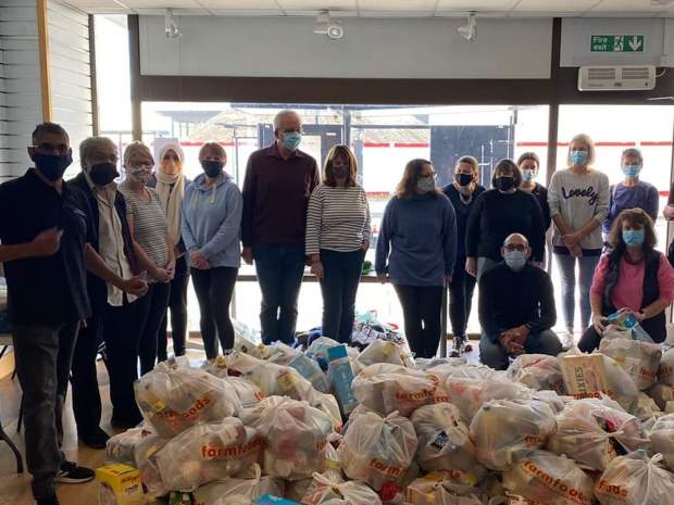 Hash Norat, far left, with just some of the volunteers and a fraction of the food parcels they deliver for Gloucester Feed the Hungry.