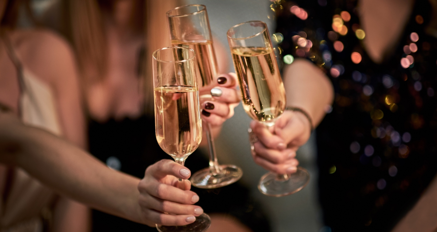 Three friends toasting with Champagne