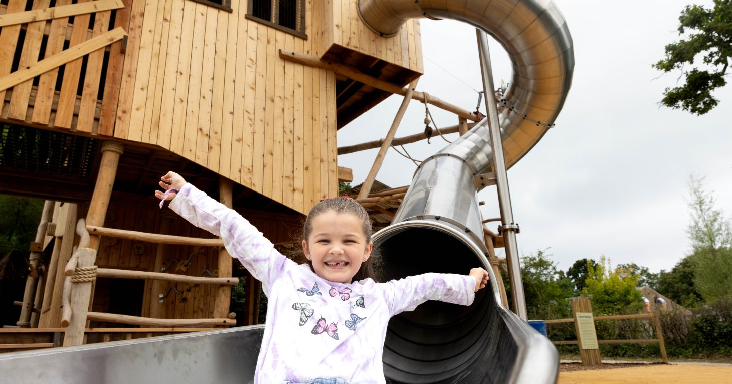 Play tester on the slide at Explorers Basecamp adventure playground at Bristol Zoo Project