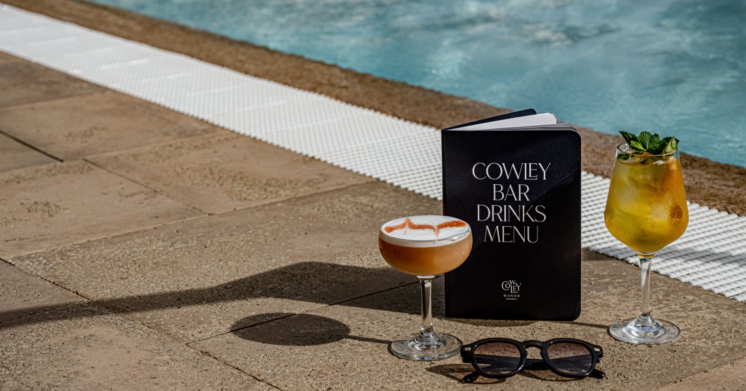 Cowley Manor C-Side Spa outdoor pool with cocktails from the poolside bar
