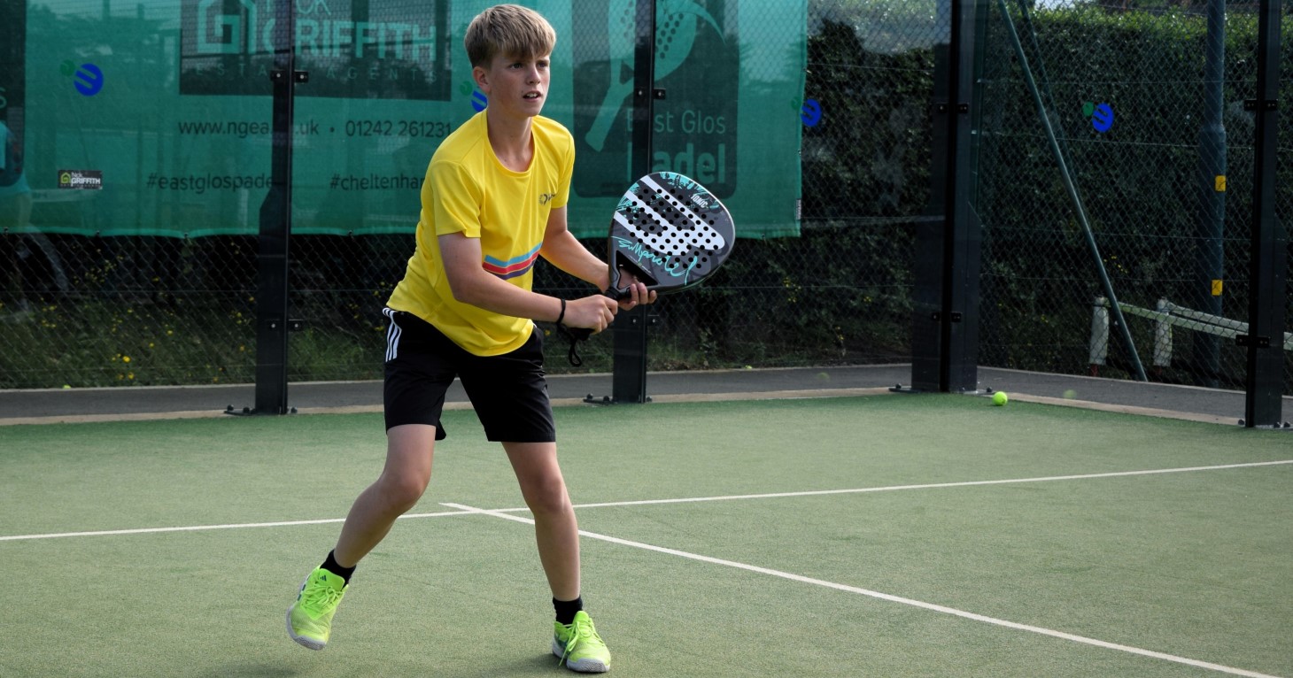 Charlie, age 13, playing padel on a court at East Glos Club in Cheltenham.
