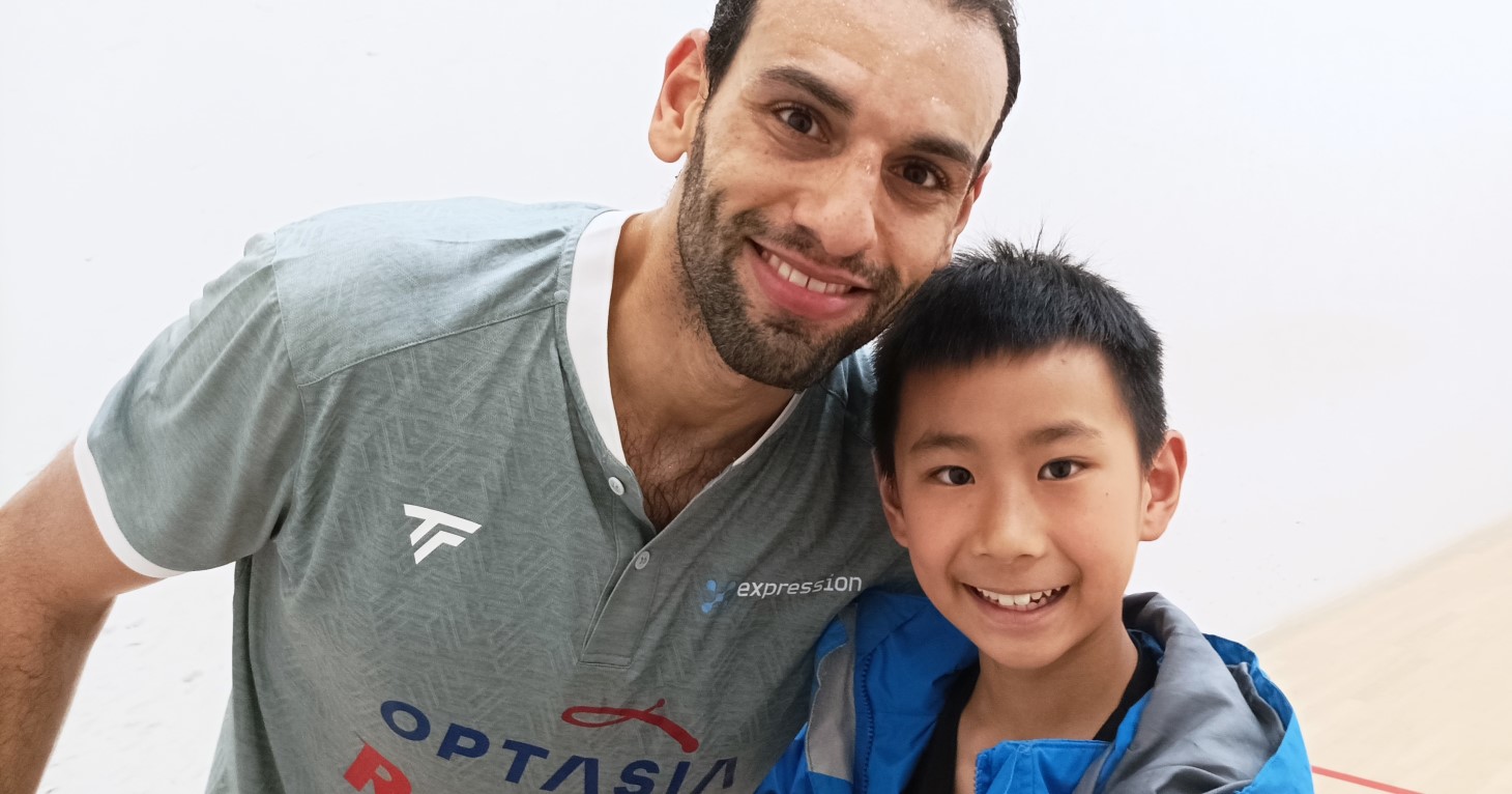 Matthew, age 14, on a squash court at East Glos Club in Chetlenham with professional squash player Mohamed ElShorbagy.