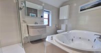There are five bedrooms in total, with the master bedroom having its own ensuite with jacuzzi bath.