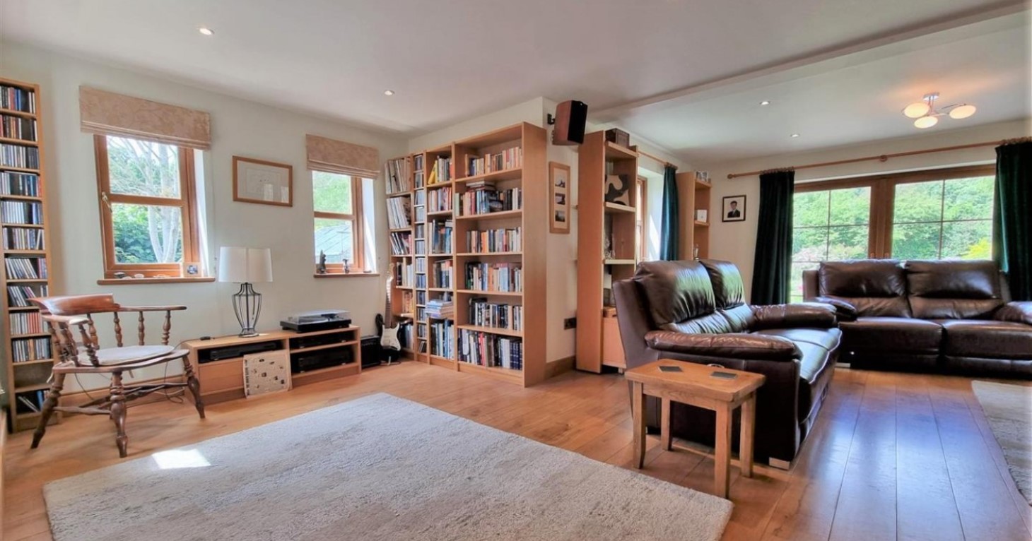 The spacious lounge provides a fantastic, flexible living space with a wood-burning stove creating a focal point.