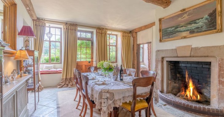 The open fireplace in the dining room only adds to the charm of this elegant abode, ideally set up for family get-togethers and celebrating in style.